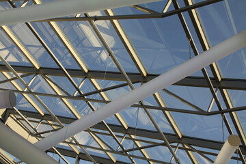 Fototapeta premium graphic roof construction made of glass, flooded with light