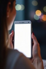 Woman sits in front of a blank mobile screen with fingers on the surface, still life, focus