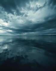 Obraz premium Dark, still water reflecting an ominous sky, subtle ripples, dark water, peaceful, moody