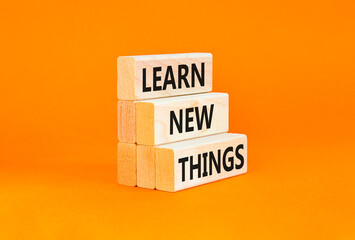 Naklejka premium Learn new things symbol. Concept words Learn new things on beautiful wooden blocks. Beautiful orange table orange background. Business motivational learn new things concept. Copy space.