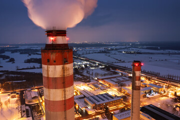 Chimenys of the coal power plant Opatovice nad Labem in winter evening produce electricity and heating for east bohemia households. Industrial landscape.