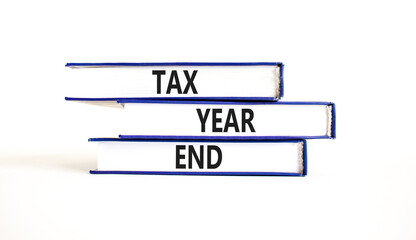 Tax year end symbol. Concept words Tax year end on beautiful blue white books. Beautiful white background. Business tax year end concept. Copy space.