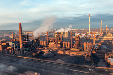 Smelter with blast furnaces from above during autumn morning. Heavy industry plant during sunrise.