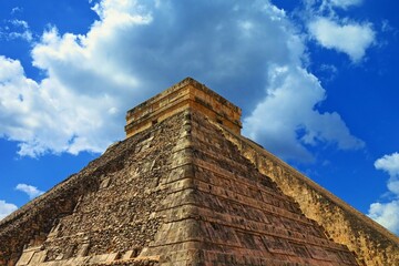 Temple of Kukulcan - El Castillo under the sunny mexican sky. Famous mayan pyramid in Chichen Itza.