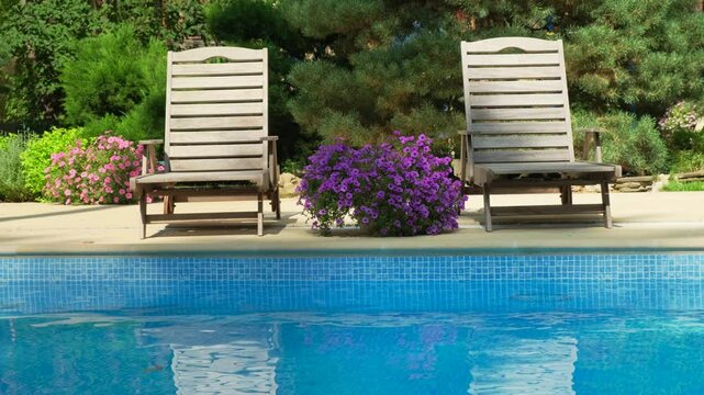 Poolside Loungers and Inflatable Float &ndash; Summer Vibes. Chilling by the Pool with Inflatable Float and Loungers. Summer Poolside. Relaxing Summer Day