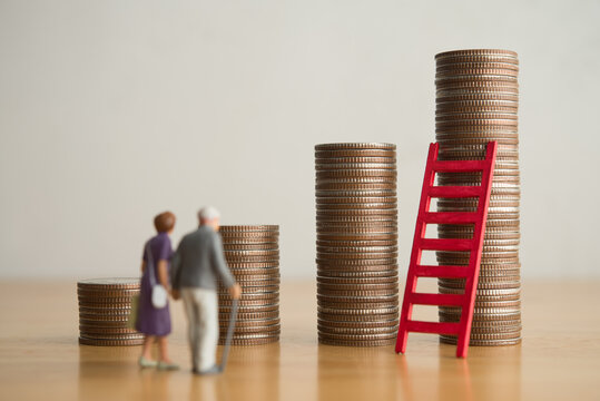 Old senior couple person standing looking at growth stack coins graph chart and red ladder. Financial planning for retirement, savings, pension, return on investment and so on concept.