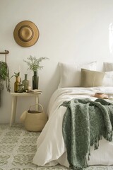 Calm bedroom interior with green throw blanket, plants, and hat.
