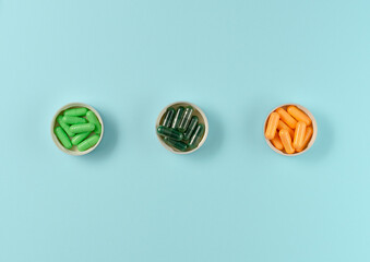 Three types of pills on blue background. Flat lay, top view.