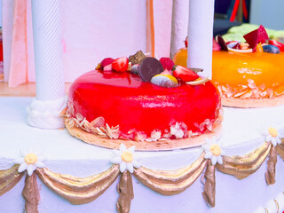 Delicious glazed cakes with fresh fruits in a celebration setting