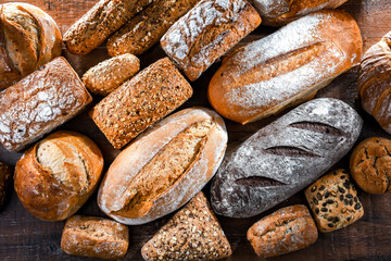 Assorted bakery products including loaves of bread and rolls