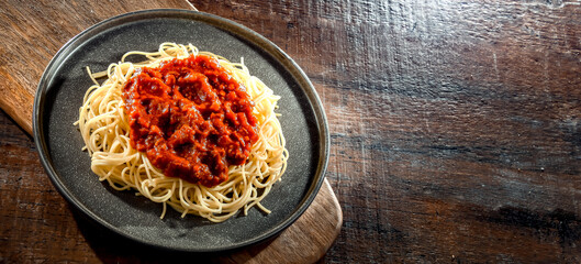 Composition with a plate of spaghetti bolognese