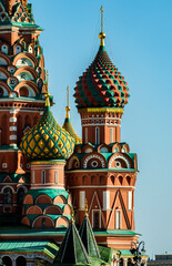 Domes of the Cathedral of the Intercession of the Most Holy Theotokos on the moat on Red Square in Moscow on a sunny day against a blue sky