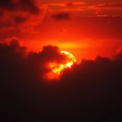 Fototapeta premium Fiery orange sun peeking through thick, dramatic sunset clouds, dusk, fiery