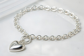Silver chain bracelet with a heart charm isolated transparent background