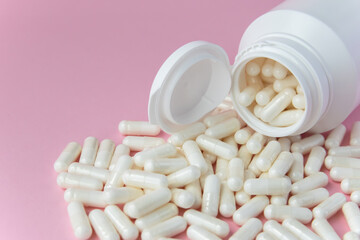Much medical pills and drugs in white package on the pink background. Healthcare concept. Space for...