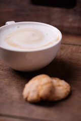 Cappuccino on dark wooden background. Soft focus. Close up.	