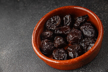 Dried prunes drained smoked plum delicious gourmet food background on the table rustic food top view copy space keto and paleo diet vegetarian and vegan food