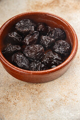 Dried prunes drained smoked plum delicious gourmet food background on the table rustic food top view copy space keto and paleo diet vegetarian and vegan food