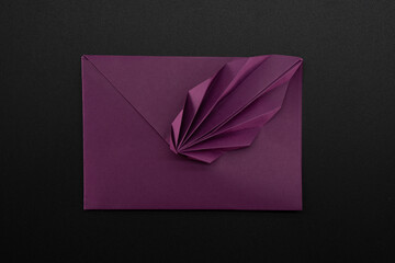 Paper envelope made of paper on a black background. Origami. Paper crafts