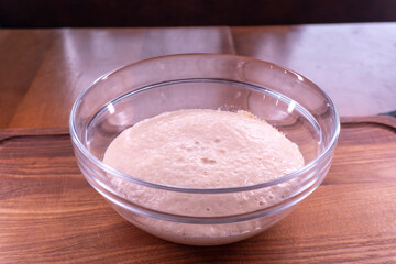 Yeast dough in a bowl.  Cooking process. Selective focus
