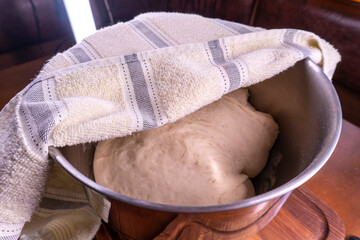 Yeast dough in a bowl.  Cooking process. Selective focus