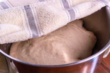 Yeast dough in a bowl.  Cooking process. Selective focus