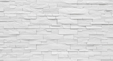 Obraz premium A clean, textured white stone wall composed of various rectangular stones arranged in an interesting pattern. Ideal for backgrounds, interior design inspiration, and modern aesthetics.