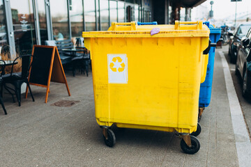 Yellow and blue Recycling Bin for plastic Waste. Waste containers for garbage segregation in Poland. Environmental conservation saving planet from contamination