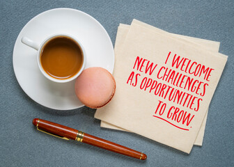 I welcome new challenges as opporutnities to grow - positive affirmation on a napkin with coffee