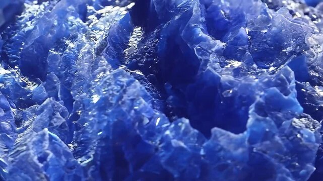 Close-up of vibrant blue Sodalite crystal formations with sharp edges and reflective surfaces mineral pattern texture macro background.