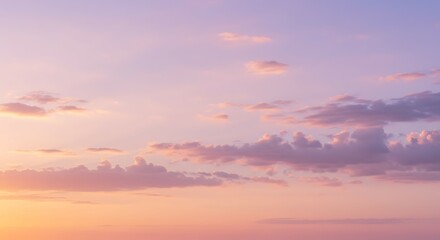 Obraz premium Beautiful pastel sunset sky with soft clouds in shades of pink, purple, and orange, creating a serene and dreamy atmosphere, perfect for backgrounds and artistic inspiration.