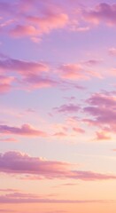 Fototapeta premium Beautiful pastel sunset sky with soft clouds in shades of pink, purple, and orange, creating a serene and dreamy atmosphere, perfect for backgrounds and artistic inspiration.