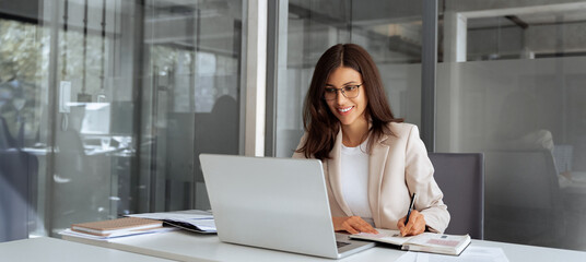 Middle age woman using laptop computer for business studying, having videocall with online virtual...