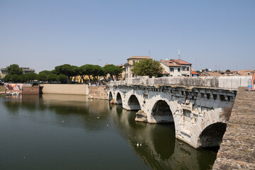 Fototapeta premium The ancient Roman Ponte di Tiberio in Rimini, Italy, gracefully arching over the water and reflecting centuries of history.