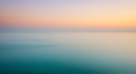 Obraz premium Calm Sea at Sunset with Soft Pastel Sky Hues and Reflections