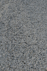 White quartz pebbles of beach, Sardinia create a unique textured backdrop.