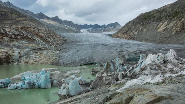 Timelapse, view of melting glacier in the Swiss Alps. Rhone Glacier, the source of the river Rhone. Furka Pass, Canton Valais, Switzerland