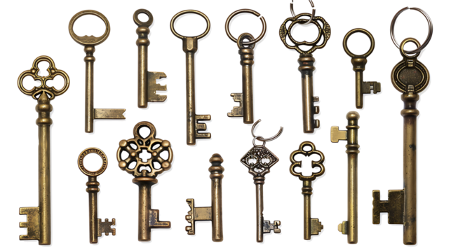 Set of keys with metallic finish and keyring attachment, isolated on a white background