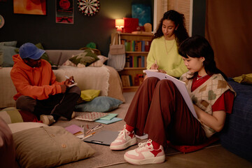 Group of multiracial students studying in cozy study room with ambient lighting and comfortable...