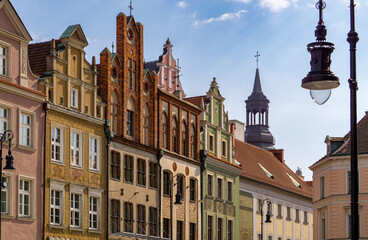 beautiful renovated tenement houses on the old market square in Poznan in Poland. decorated tenement houses after renovation. old beautiful urban architecture against the blue sky spring.
