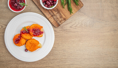 Baked Camembert brie crispy with fresh berries and cranberry sauce with rosemary. appetizer. top view. copy space