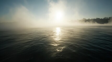 Obraz premium The sun shines over water through a blanket of morning mist