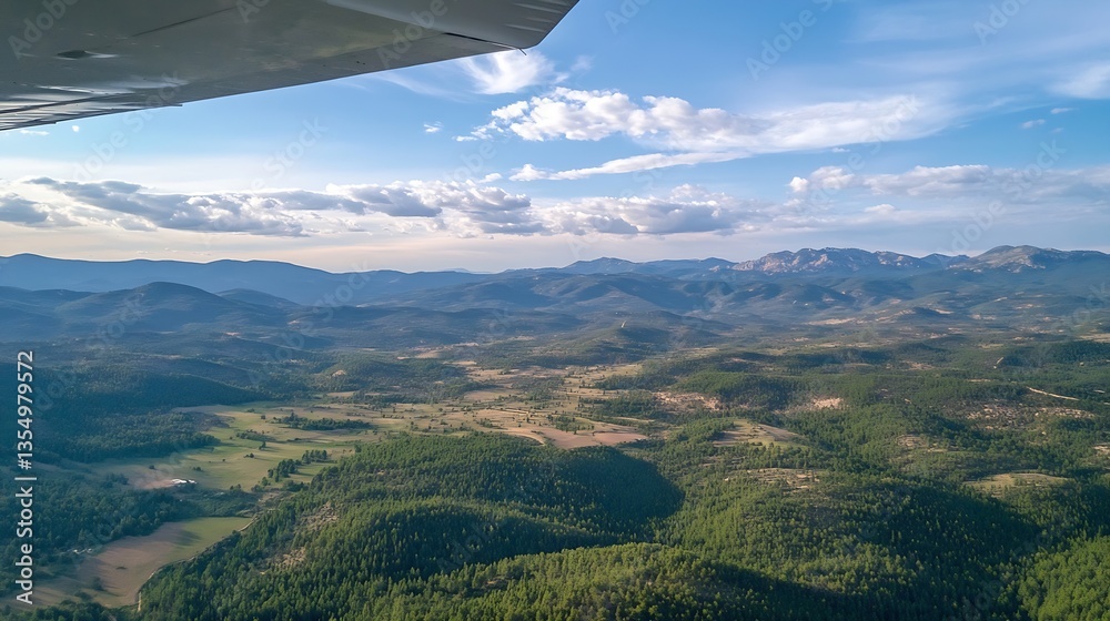 Poster aerial view of majestic mountain landscape with lush green forests and open fields under a bright bl