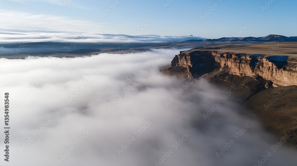 Aufkleber breathtaking aerial view of majestic cliffs emerging from the dense fog on a clear day : generative 