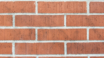 Close-Up of a Red Brick Wall with White Grout
