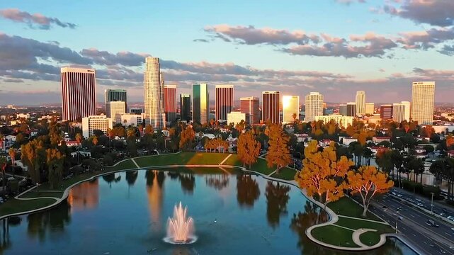 Aerial Time Lapse Over Echo Park of Downtown Los Angeles California Skyline and Skyscrapers During Golden Hour.
