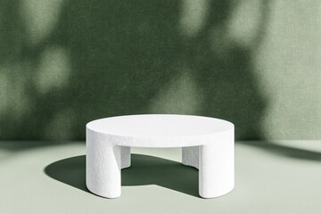 Minimalist white pedestal on a muted green background.  Soft shadows cast by foliage