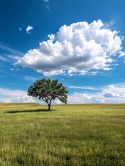 Fototapeta premium Solitary tree stands in wide green field beneath dramatic sky filled with clouds : Generative AI