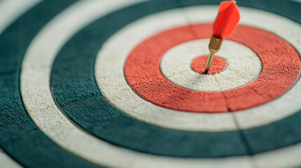 A close-up view of a dartboard, featuring a dart embedded in the bullseye, showcasing vibrant colors and concentric circles.