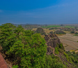 Trang An River Ninh Minh and Bai Dinh Mountain ranges in Vietnam only 3 hours drive from Hanoi. Beautiful winding river and large rising mountains. boats going through the caves in the river